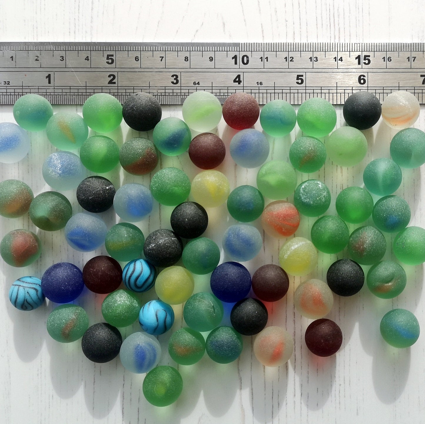 Eco-friendly tumbled glass marble assortment in various colours, highlighting their sustainable and artistic appeal