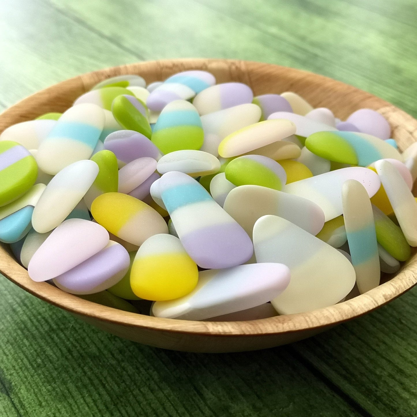 Creative multicoloured tumbled glass, on a dark background. Showing their weathered smooth look, with many uses in home decor crafts