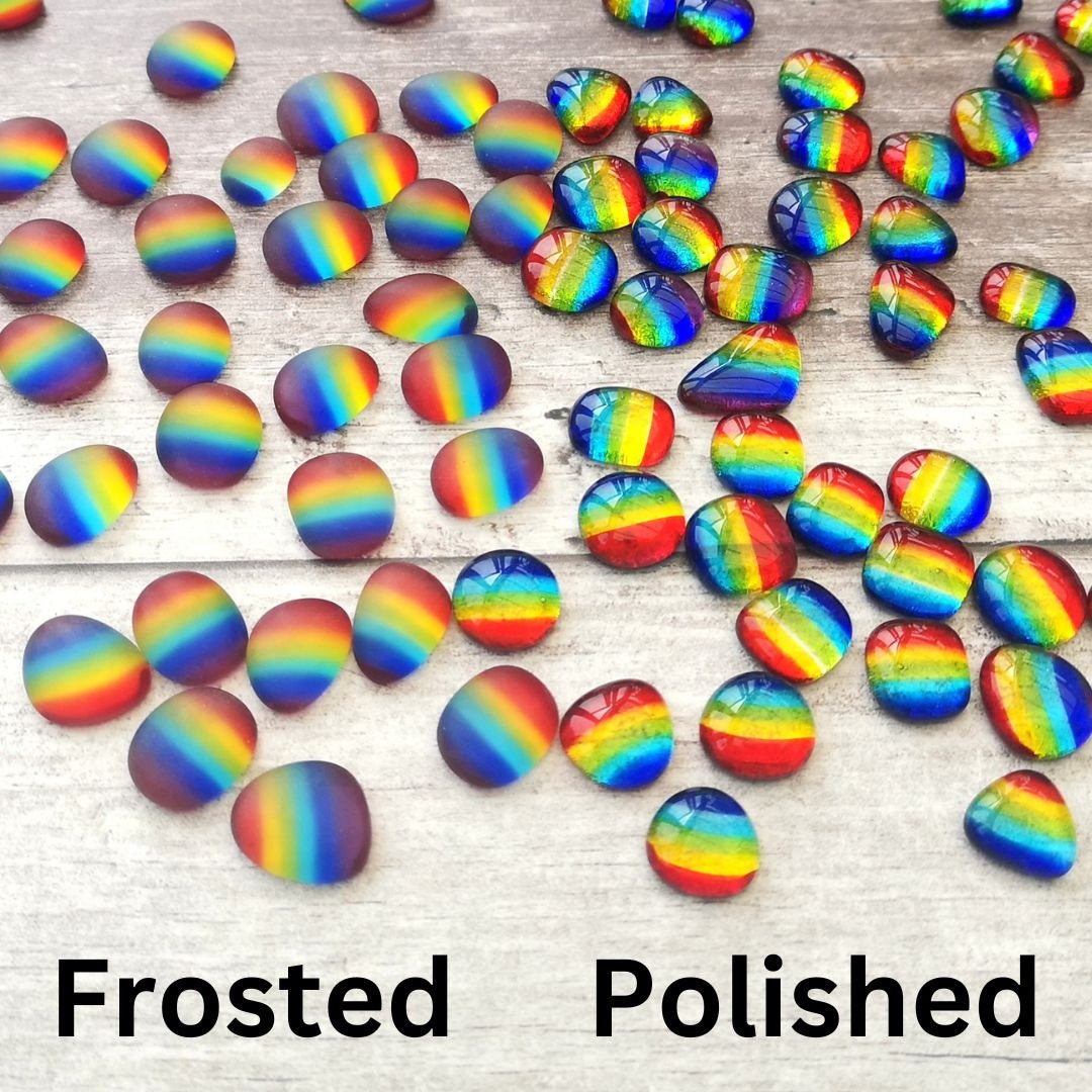 Richly coloured tumbled glass assortment on a wood backdrop, focusing on the difference between the polished or raw, frosted texture finishes, ideal for eclectic art and design projects