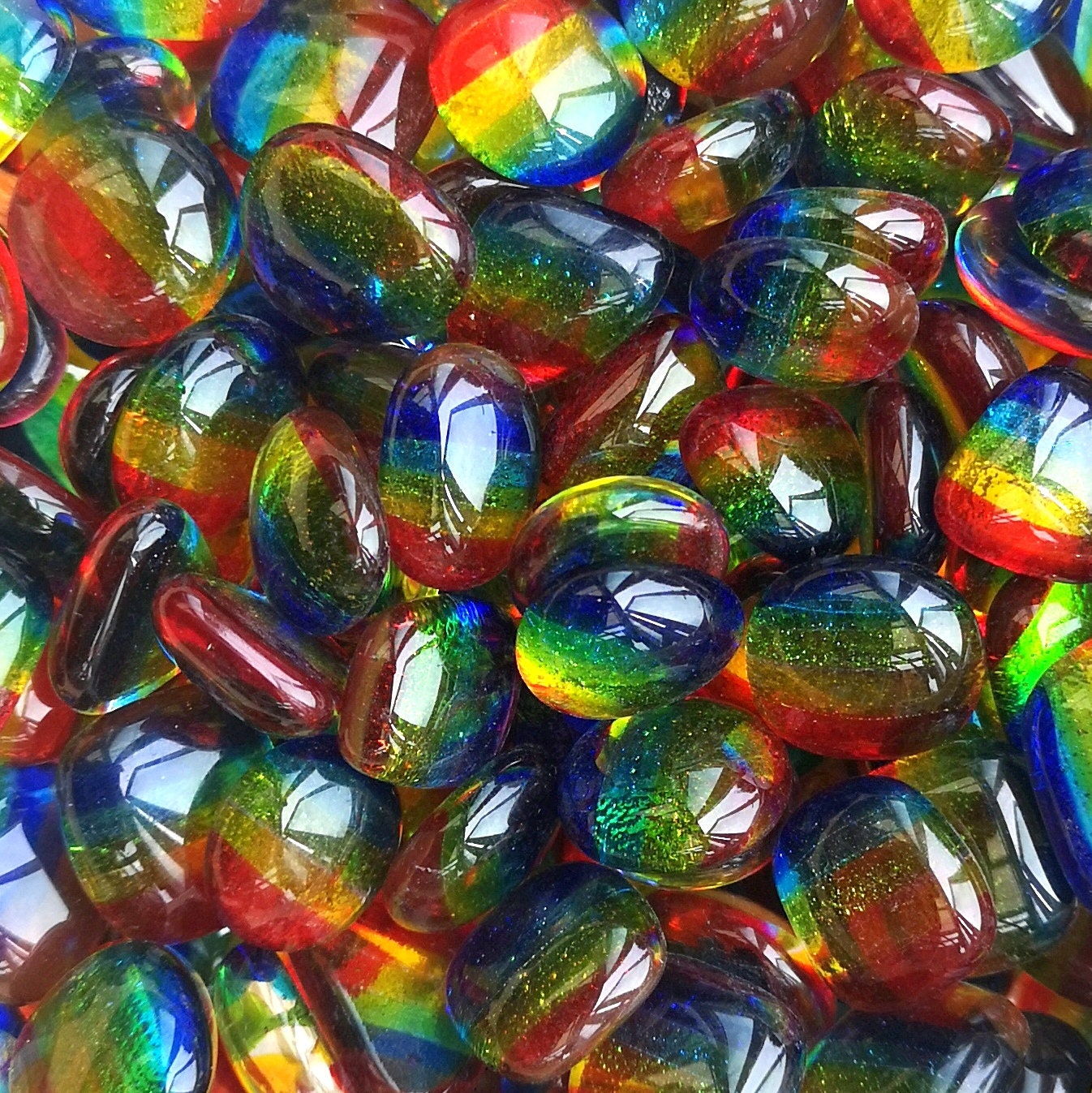Creative multicoloured tumbled glass, on a dark background. Showing their polished smooth and shiny look, with many uses in home decor crafts