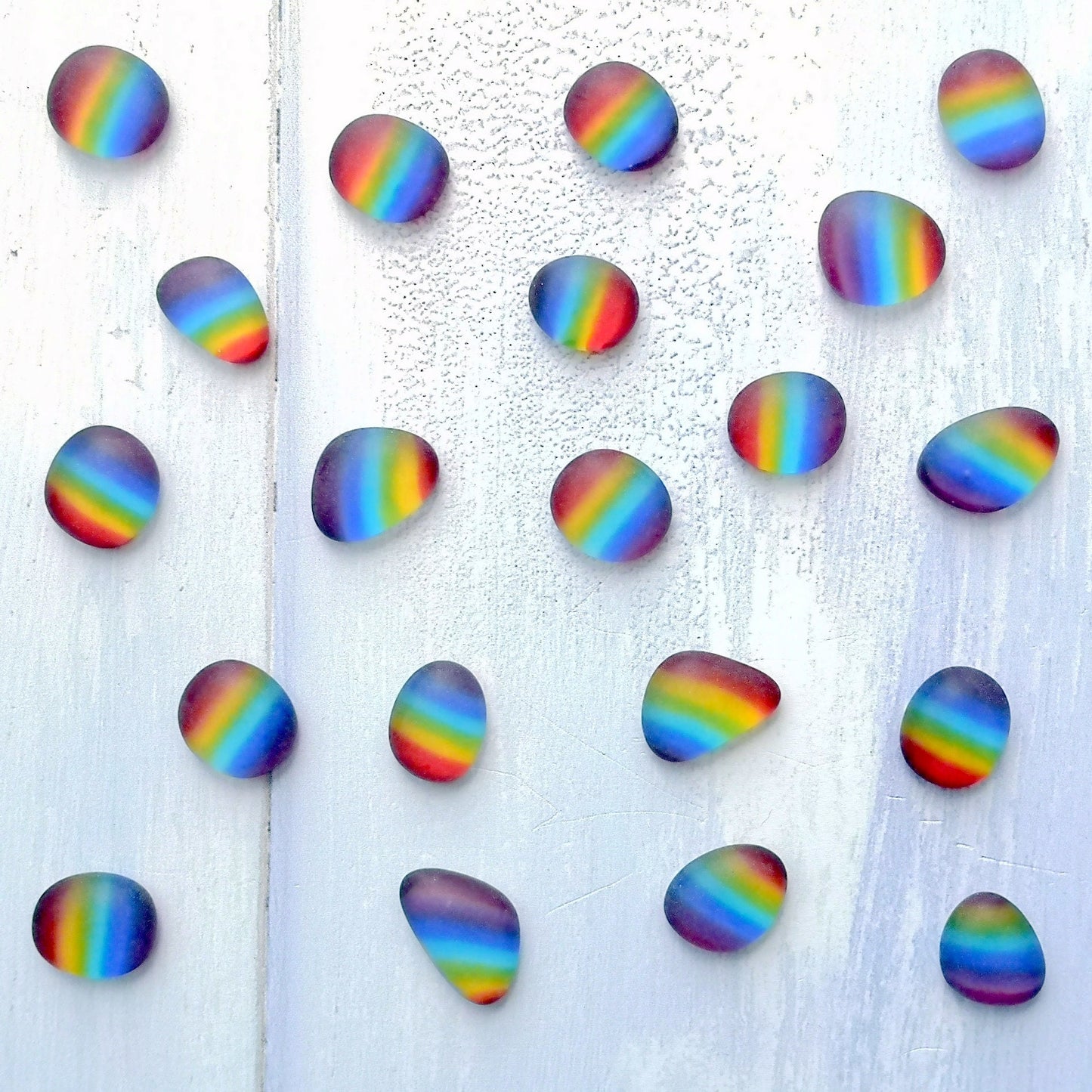 Sustainable rainbow multi coloured tumbled glass collection, environmental friendliness, recycled glass