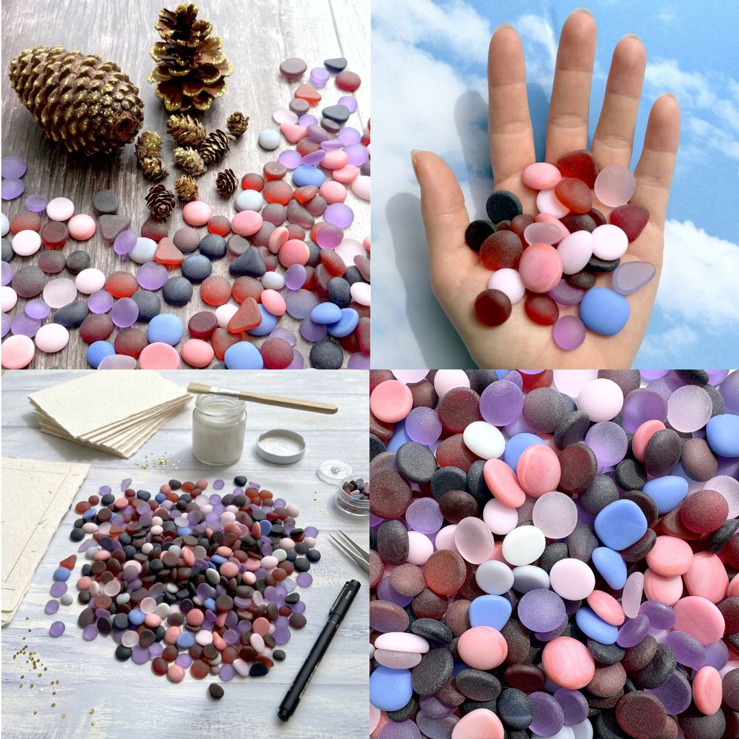 A four-panel collage showing round, flat decorative tumbled glass or pebbles in many colours. The top-left panel shows the stones scattered on a wood surface with pinecones nearby; the top-right panel shows a hand holding a handful of the sea glass against a blue sky background; the bottom-left panel shows the frosted glass arranged with small craft supplies on a white table; the bottom-right panel is a close-up of the multicoloured stones.